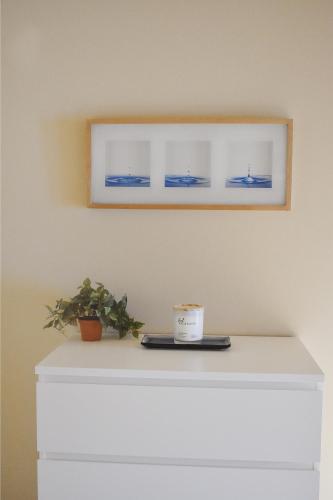 a white dresser with a cup on top of it at Villa Luna in Gig Harbor