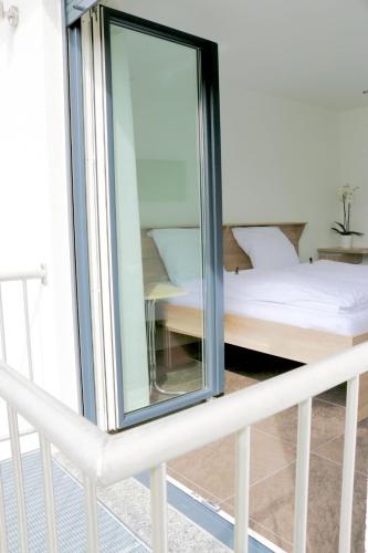 a mirror on top of a bed in a room at Alte Stadtmauer - Apartment in Sinsheim