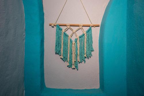 a towel hanging on a wall next to a surfboard at Colibri Hotel in Cabo Corrientes