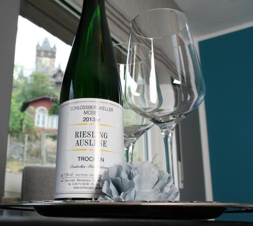 a bottle of wine and a glass on a table at Weinburg -Das Ferienhaus in Cochem