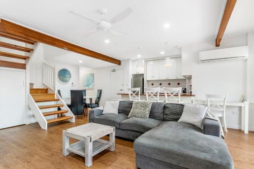 a living room with a couch and a table at Santa Fe by the Broadwater in Gold Coast