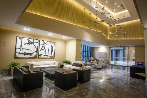 a lobby with couches and chairs in a building at Skytel Hotel Chengdu-City Center in Chengdu