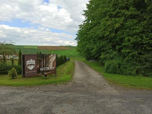 a dirt road with a sign on the side at Leśny Zakątek Radocza in Radocza
