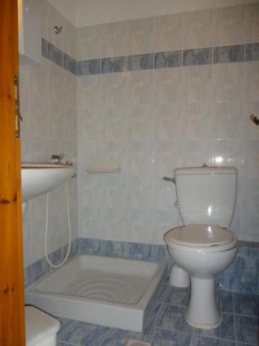 a bathroom with a toilet and a bath tub at Marinos Studios at Lourdata village in Lourdhata