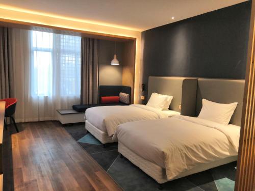 Ένα ή περισσότερα κρεβάτια σε δωμάτιο στο Holiday Inn Express Pinghu by IHG