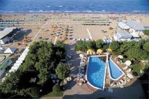 an aerial view of a beach with a swimming pool at Atene Albergo Riccione in Riccione