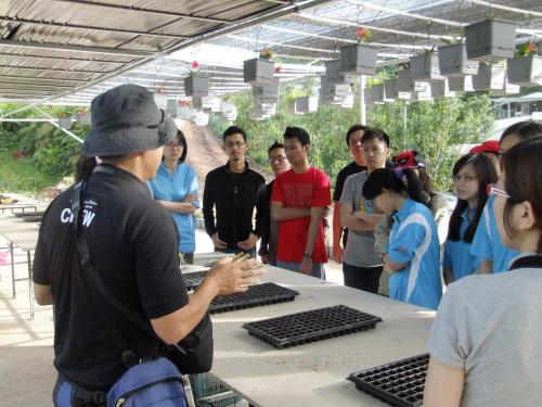 a group of people standing around a table at Moonriver Lodge in Cameron Highlands