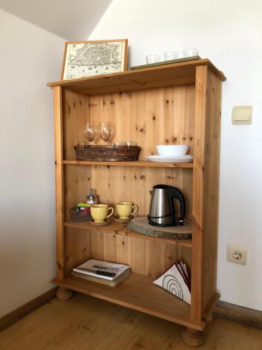 a wooden shelf with bowls and dishes on it at Viesu nams Vālodzes in Sigulda