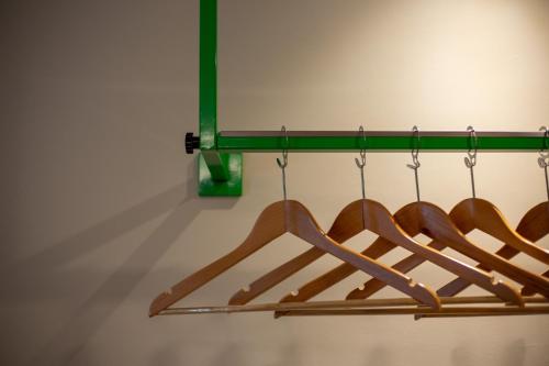 a bunch of wooden hangers in a closet at Lemontea Hotel Bangkok in Bangkok
