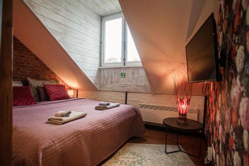 a bedroom with a bed with towels on it at Luxury Suites Historic Center by Rikas Hotels in Antwerp