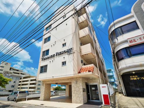 a white building on the side of a building at Terrace Resort Shintoshin in Naha