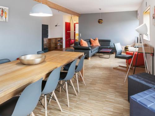 a living room with a wooden table and chairs at Splendid Holiday Home in Freital with Sauna in Freital