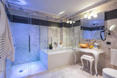 a bathroom with a shower and a tub and a sink at Carnival Palace - Venice Collection in Venice