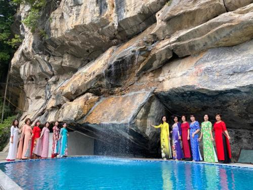 a group of people standing in a cave in the water at Trang An Memory Homestay in Ninh Binh