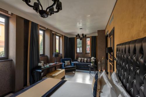 a hotel room with a bed and a living room at Carnival Palace - Venice Collection in Venice