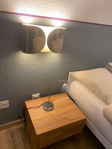 Postel nebo postele na pokoji v ubytování Hôtel Maison Blanche