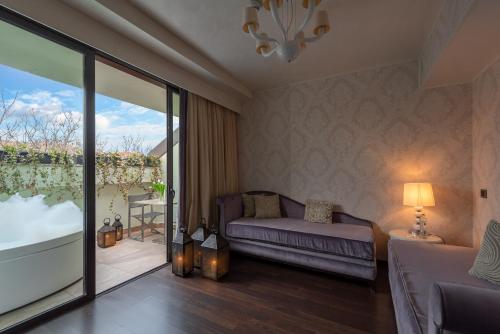 a living room with a couch and a balcony at Carnival Palace - Venice Collection in Venice