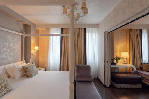 a hotel room with a large bed and a couch at Carnival Palace - Venice Collection in Venice