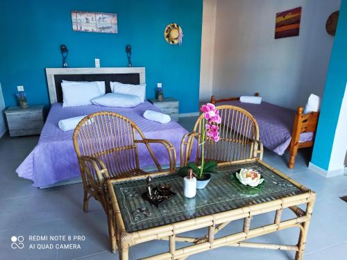 a bedroom with a bed and a table with flowers on it at Gardenia House in Asos