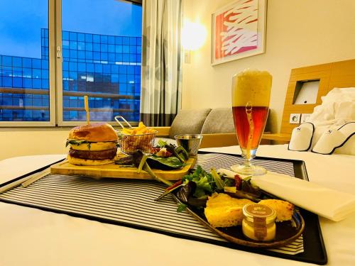 a tray with a sandwich and a drink on a table at Novotel Lille Centre Gares in Lille