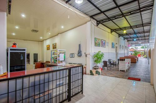 a large room with a bar and a dining area at Hotel Bambu Kuning in Bandar Lampung