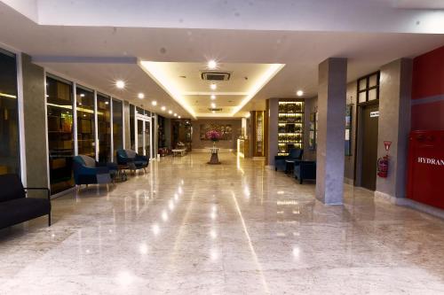 a hallway of a hospital with couches and chairs at Ayani Hotel Banda Aceh in Banda Aceh