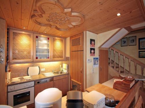 a kitchen with a stove and a sink in a room at Ferienwohnung Vogel in Siegsdorf