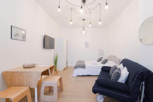 a living room with a couch and a bed at Studio Family Marseille Parking Clim - MaisonMars in Marseille