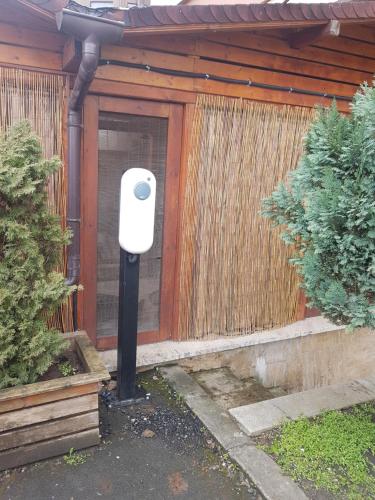 a mailbox in front of a house with a fence at Boutique Vila Paradis in Deva