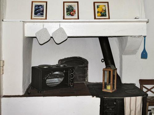 a fireplace with a microwave on top of it at 6 person holiday home in Vislanda-By Traum in Vislanda