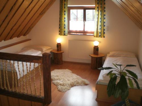 a bedroom with two twin beds and a window at Chalupa Štrba in Štrba
