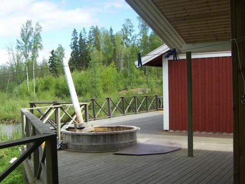 a patio with a fire pit on a deck at 8 person holiday home in GR NNA in Målskog