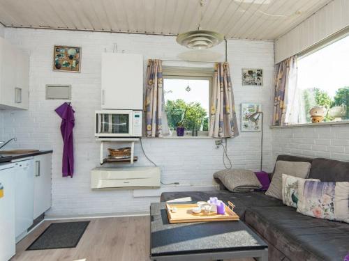 a living room with a couch and a table at 3 person holiday home in Gråsten-By Traum in Rønsheved