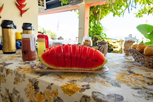 a slice of watermelon sitting on a table at Pousada Sobre As Ondas de Picinguaba in Picinguaba