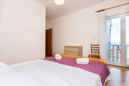 Кровать или кровати в номере Apartments Magdales