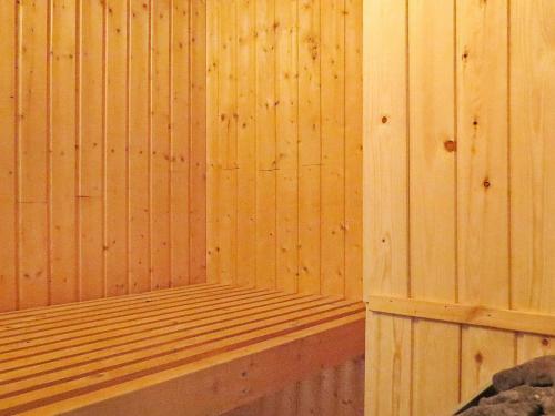 a wooden sauna with a wooden platform in a room at 10 person holiday home in Harbo re in Harboør