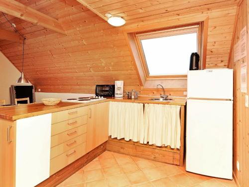 a kitchen with a white refrigerator and a window at 6 person holiday home in Ringk bing in Klegod