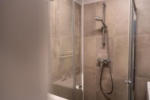 a bathroom with a shower with a glass door at Lovely apartment in the city center in Kaunas