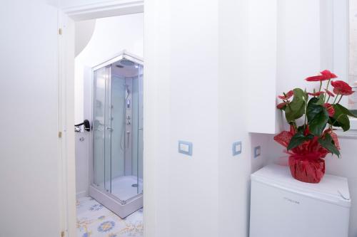 a shower with a glass door in a bathroom at Alfieri Rooms - Amalfi coast in Atrani