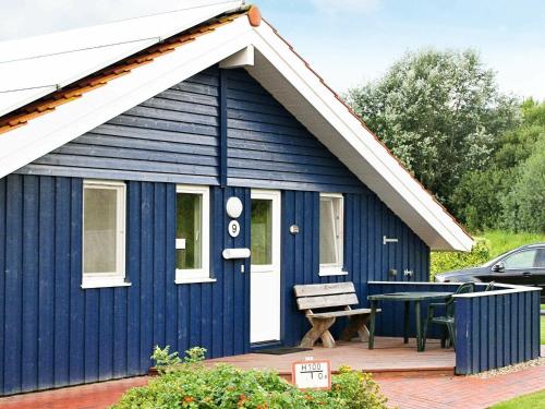 a blue shed with a picnic table in front of it at 6 person holiday home in Otterndorf in Otterndorf
