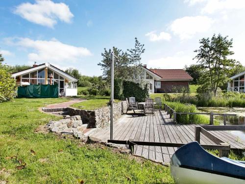 a backyard with a wooden deck and a house at 6 person holiday home in Otterndorf in Otterndorf