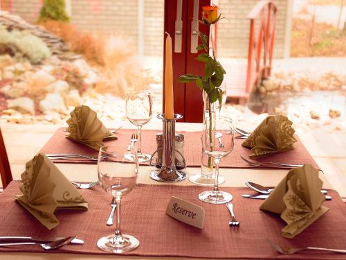 a table with wine glasses and napkins on it at Penzion Fortune in Dunajská Streda