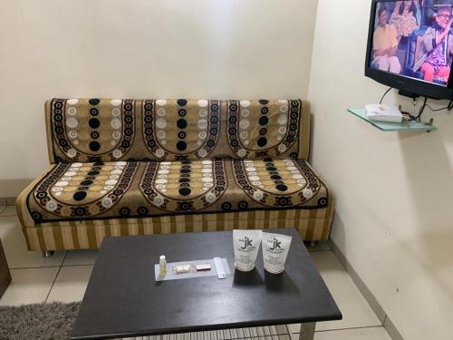 a living room with a couch and a coffee table at JK Rooms 147 Lions - Koradi Nagpur in Nagpur