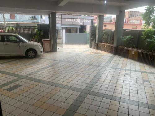 a car parked in front of a parking lot at JK Rooms 147 Lions - Koradi Nagpur in Nagpur