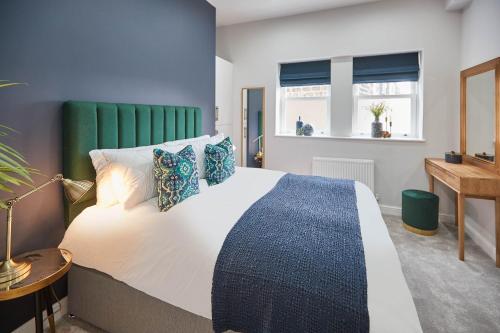 a bedroom with a large bed and a desk at Host & Stay - Green View in Harrogate