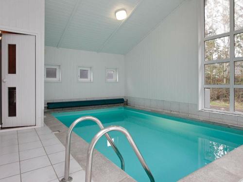 uma grande piscina com água azul num quarto em 10 person holiday home in L kken em Grønhøj