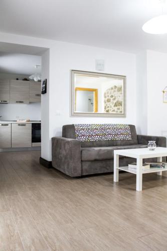 a living room with a couch and a table at Apartment Casa Rasat-2 by Interhome in Ovasta