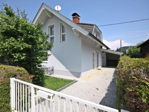 a white house with a white fence at Holiday Home Seehaus Blue Faak by Interhome in Faak am See