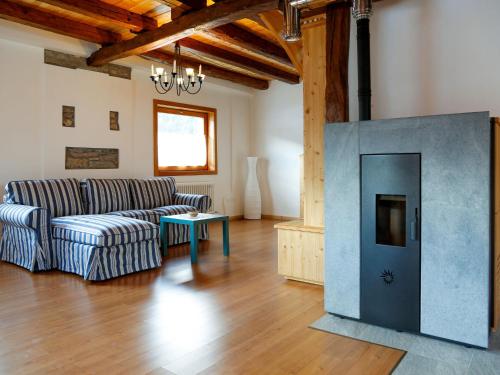 a living room with a couch and a fireplace at Holiday Home Stali di Ettore by Interhome in Ovaro