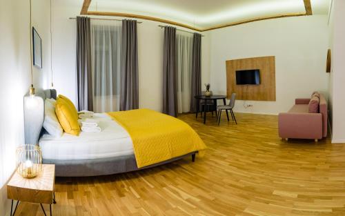 a bedroom with a bed and a living room at Pensiunea Salina Gymnasium in Turda